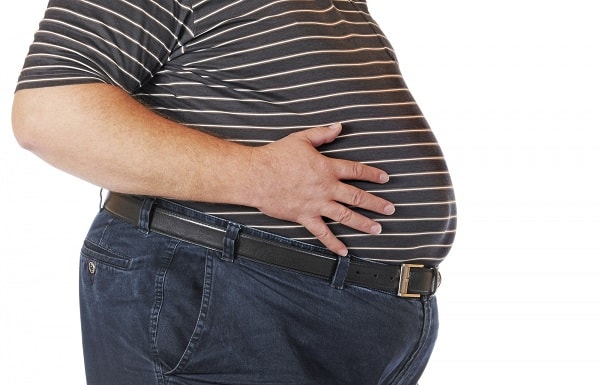 obese man touching his stomach