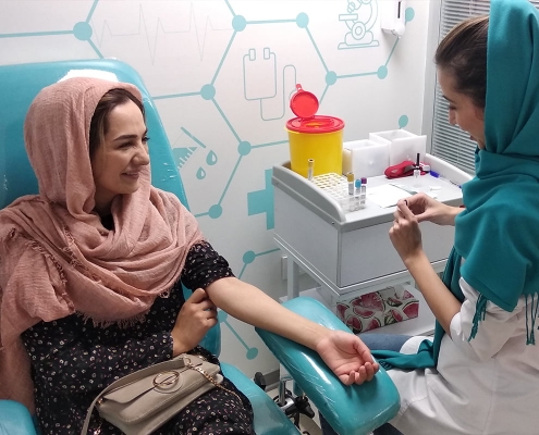 Dutch-Afghan patient getting injection by a nurse in a clinic in Tehran