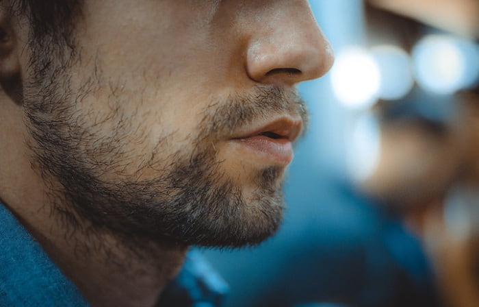 man profile with a patchy beard