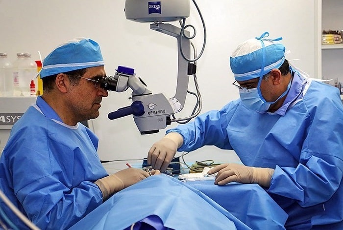two iranian eye surgeons performing ophthalmic surgery on patient