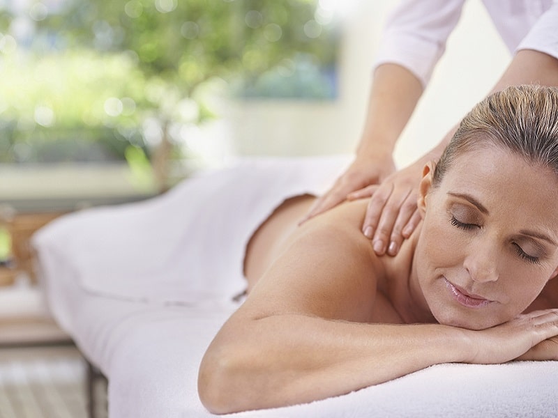 a woman receiving a lymphatic drainage massage after liposuction