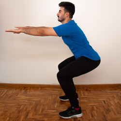 man doing stretches and knee exercises at home to treat his pain