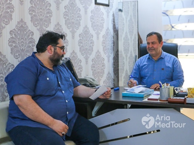 obese man in doctor's office receiving consultation before weight loss surgery