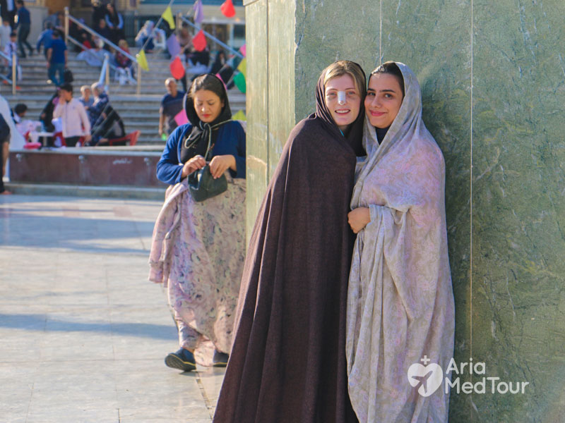 medical tourist in Iran with her translator in Imamzade Saleh holy shrine