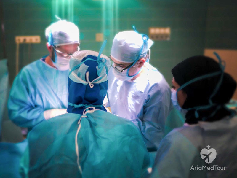 plastic surgeons operating on a patient in an operating room