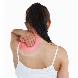 woman with shoulder pain holding her shoulder shot from behind isolated on white background
