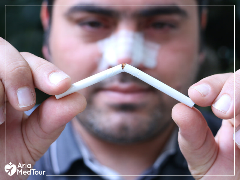 rhinoplasty patient breaking his cigarette to show that people should stop smoking after their nose job