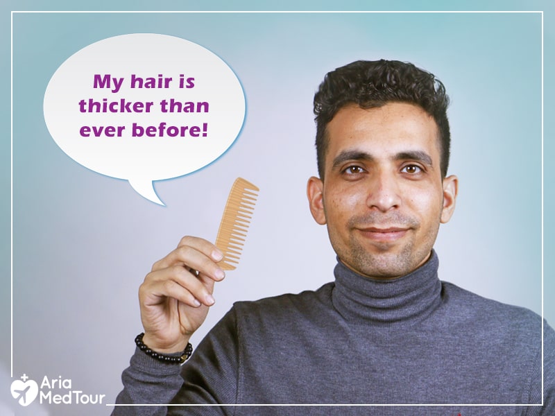 man with thick hair holding a comb